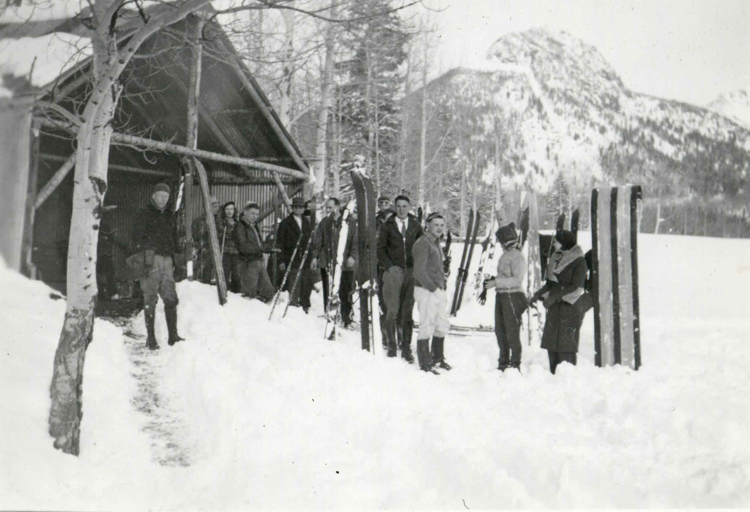 skiers outside hut